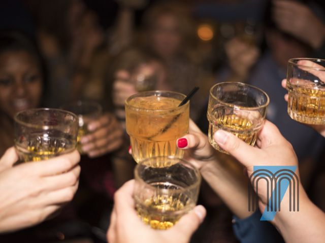 Group Toasting Drinks During a Night Out